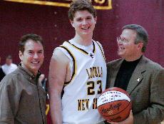 Steven McGovern, finance senior, receives an honorary ball from coach Michael Giorlando during a Senior Night ceremony at The Den on Feb. 22 before tip-off against Spring Hill. McGovern scored a basket at the dying seconds of the game, his last shot made on campus.