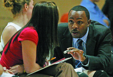 Alton Clivens, assistant womens basketball coach, discuesses stratey with fellos assistant Rachel Kovach.
