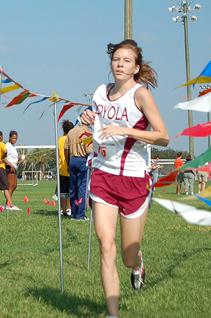 Rachel Leonard, sociology freshman, crosses the finish line at eighth place. The womens team placed secon at the Loyola/Xavier Invitational.