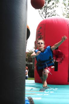 Sam Jannenga tries her skill on a bungee-rigged basketball-dunking game.