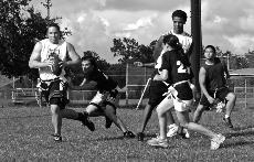 A defender grabs the flag of a scrambling opposing quarterback at last Sunday's game.