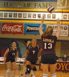 Kristie Hadley, sociology freshman, sets up middle hitter Danielle Posey, communication junior, for an attack. Loyola won the match in four games (30-26, 27-30, 30-20, 30-21).