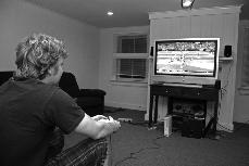 After defeating his roommates, Andy Mumm plays another round of Madden NFL 08 for practice. 