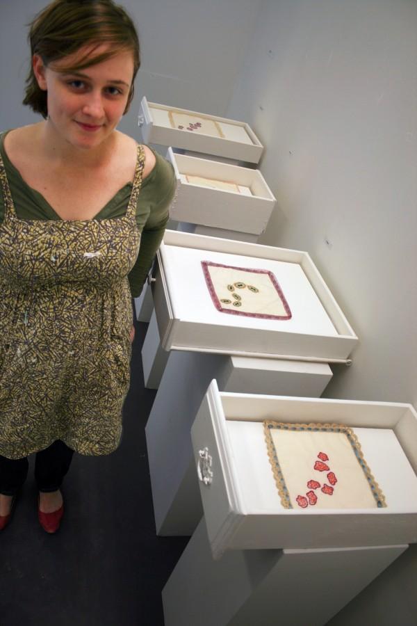 Christine Ruby stands by a section of her display, called "Contagious." Ruby received the Scully Scholarship for her work.