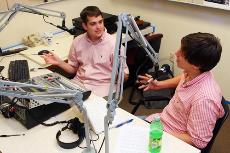 William Nunn, finance sophomore, chats with Station Manager Andrew Poland, political schience sophomore, in the studio Monday during a trial run of Loyola Sport Center with Big Will.