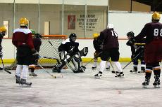 Loyola Hockey team captain Fred Dewey, economics senior, takes a practice shot against goalie Tom Sevick, biology freshman, at Leo's Ice Land in Baton Rouge, Oct. 2. 