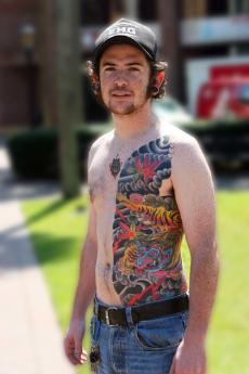 Music business senior Dave Hood displays his body art in the Pal Court. Hood, who works at Uptown Tattoos, as his back, half his torso and is left leg tattooed.