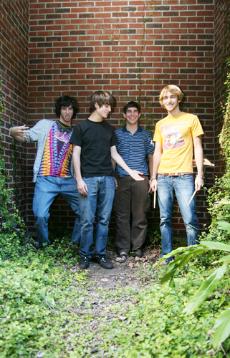 From left, Ross Farbe, Devin Hildebrand, Kile Hines amd Alex White goof off in the cove behind the Danna Center next to West Road garage.