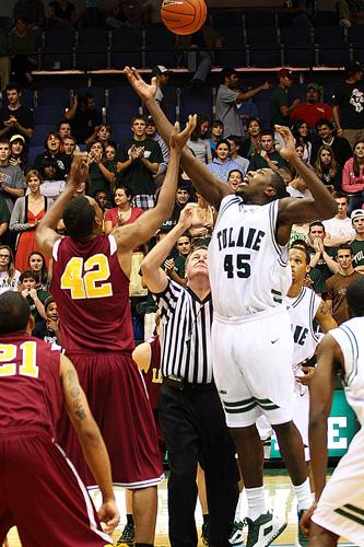 Darrinton Moncrieffe, management sophomore, and Tulane player, Robinson Louisme, battle for the ball during the opening tip-off of the game Nov. 6 at Fogelman Arena. 