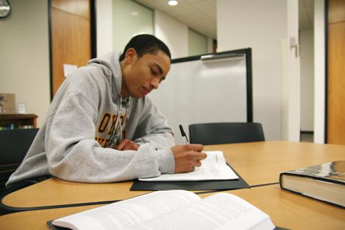 Political science freshman and basketball guard Chris Joseph studies in Monroe Library Jan. 12. Joseph was completing his required 8 hours of study time per week for the basketball team.