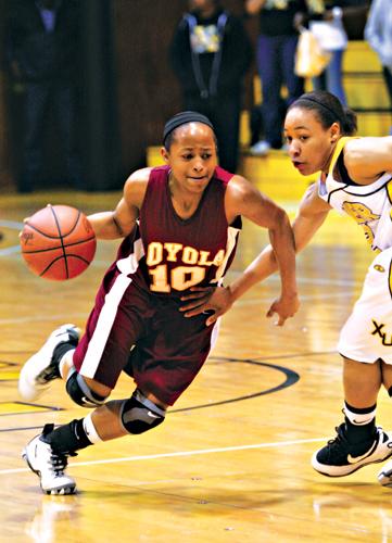 Management senior and forward/guard Trenell Smith rushes past a guard at the Jan. 29 away game against Xavier. One of Loyolas biggest rivalries, the Gold Nuggets defeated the Wolfpack 49-42. It was the ladies thirteenth consecutive loss in Xaviers gymnasium. (Photo by Kevin Zansler/The Maroon)