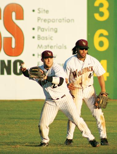 Former Loyola outfielder Brian Mason, right, watches as teammate, Stephen Carroll prepares to throw the ball