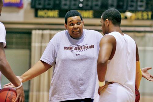 Lincoln Wright, marketing freshman, listens to Coach Hinton during practice. Hinton is in his first year as a member of Loyola's men's basketball coaching staff.