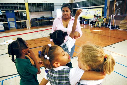 Students at Hynes Elementary School receive instructions from Alexcia Plummer, music performance junior, March 10. Plummer works with the after school program A's and Aces.