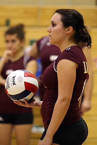 Stacey Kersten, mass communication senior, gets ready to serve. Kersten returned to them team after oercoming injury.