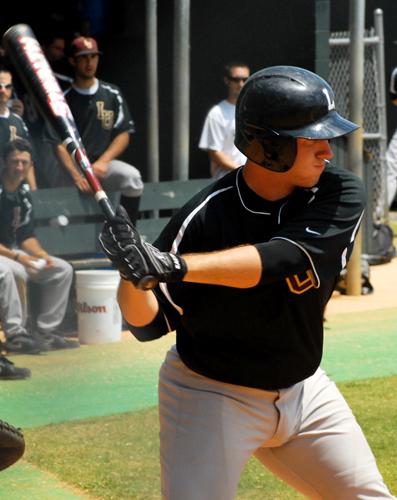 Brien Delahoussaye, accounting freshman, swings at a pitch against the University of Mobile.