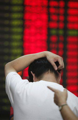 An investor reacts as he looks at a stock price monitor at a private securities company Thursday Sept. 10, 2009, in Shanghai, China. Chinese shares fell Thursday for the first time in September after a seven-day rally as profit-taking investors were waiting for August's economic data due to be released Friday.