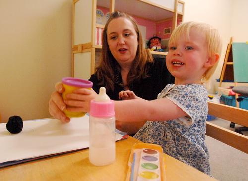 Dr. LeAnne Steen, interim chairwoman of the Department of Counseling, works with a child in the play therapy lab. Steen said children are able to express complex emotions through play.