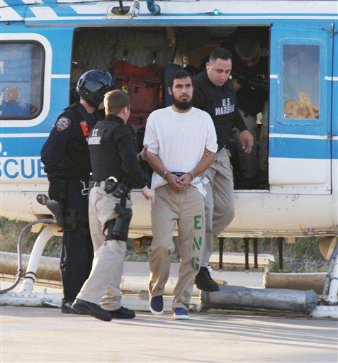 In this photo released by the New York City Police Department, Najibullah Zazi, center, is escorted off an NYPD helicopter by U.S Marshals after being extradited from Denver, Colo., Friday, Sept. 25, 2009. Zazi was sent to New York to face charges of conspiracy to use weapons of mass destruction in a plot law enforcement has said was focused on blowing up commuter trains.