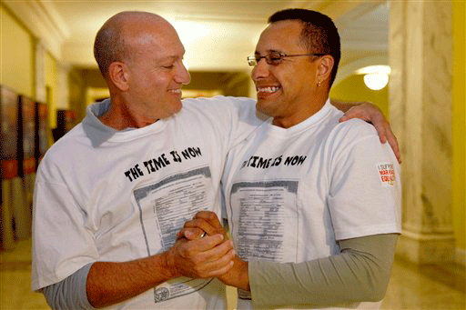 Ed Grandis, left, and Juan D. Rondon, hug after a bill allowing same-sex marriage in the District of Columbia was introduced at a city council meeting in Washington, on Tuesday, Oct. 6, 2009.