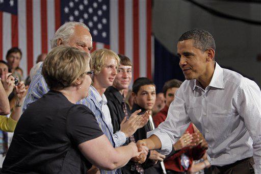 FILE - In this Aug. 15, 2009, file photo President Barack Obama, right, shakes hands during a town hall meeting about health care in Grand Junction, Colo. Colorado, which has shifted from Republican-leaning to Democrat-friendly in recent years, had seen Obama officials 35 times through early August, including Obama's Feb. 17 trip to Denver to sign the stimulus bill into law.