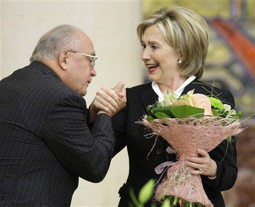 U.S. Secretary of State Hillary Rodham Clinton reacts, as MGU head Viktor Sadovnichy presents her with flowers after she addressed students of MGU ( Moscow State University), in Moscow, Wednesday, Oct. 14, 2009.