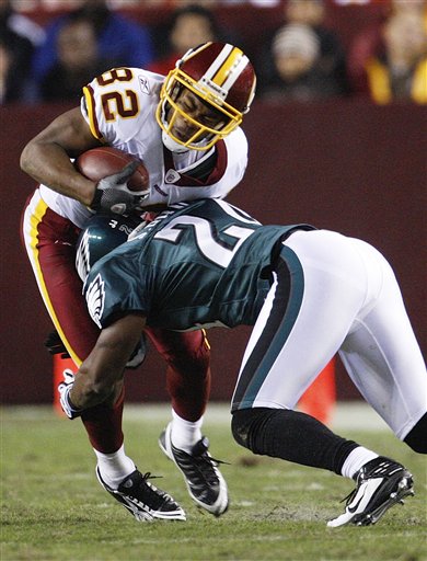 Washington Redskins wide receiver Antwaan Randle El is stopped by Philadelphia Eagles cornerback Sheldon Brown during the first half of the NFL football game Monday, Oct. 26, 2009 in Landover, Md.