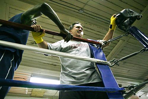 The Rev. Kevin Wildes, S.J., university president, takes off his boxing headgear after a match against a Tulane University student Oct. 16