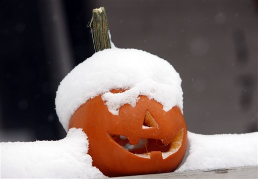 Snow tops a pumpkin carved for Halloween that sits on the rail outside a home in Denver as an autumn storm dumps up to two feet of snow on parts of the intermountain West on Thursday, Oct. 29, 2009. Forecasters predict that that the snow will continue to fall through the day on Thursday before moving out of the area.