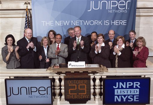 In this photo released by the New York Stock Exchange, Thursday, Oct. 29, 2009, executives and guests with Juniper Networks, Inc. attend the opening bell ceremony. The Sunnyvale, Calif.-based technology company moved Thursday from Nasdaq to the NYSE Euronext. Investors heartened by news of a stronger-than-expected economy went back into the stock market after a four-day slide. 