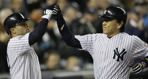 New York Yankees' Hideki Matsui, right, is congratulated by Jerry Hairston Jr. after hitting a home run against Philadelphia Phillies' Pedro Martinez during the sixth inning of Game 2 of the Major League Baseball World Series Thursday, Oct. 29, 2009, in New York.