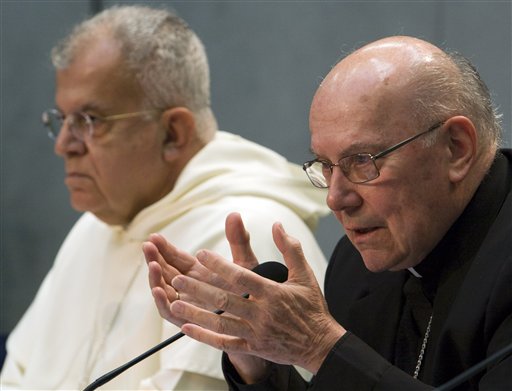 Cardinal William Levada, right, the Vatican's chief doctrinal official, flanked by Archbishop Joseph Augustine Di Noia, Secretary of the Congregation for Divine Worship and the Discipline of the Sacraments, speaks at a news conference at the Vatican, Tuesday, Oct. 20, 2009. The Vatican has made it easier for Anglicans to join the Catholic Church, responding to the disillusionment of some Anglicans over the election of openly gay bishops and the blessing of same-sex unions. Pope Benedict XVI appr