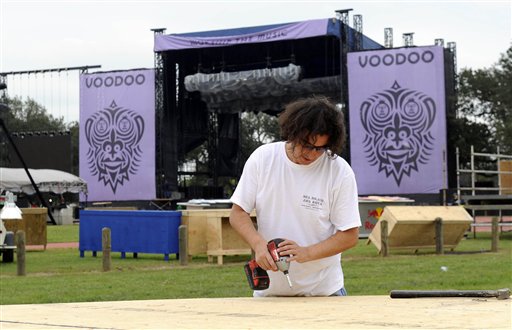 Ryun Mouton builds a dance floor as crews work to get the main stage ready for the Voodoo Experience Holloween weekend concert, in New Orleans Wednesday, Oct. 28, 2009. 