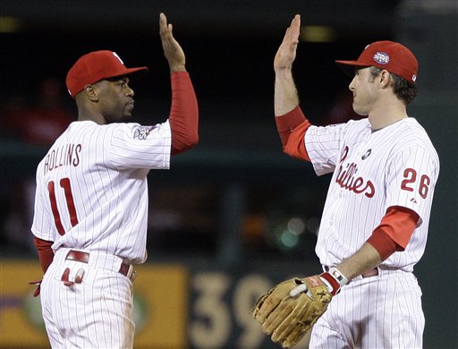 Philadelphia Phillies' Jimmy Rollins (11) and Chase Utley celebrate after the ninth inning of Game 5 of the Major League Baseball World Series against the New York Yankees Monday, Nov. 2, 2009, in Philadelphia. The Phillies won 8-6 and the Yankees lead the series 3-2.