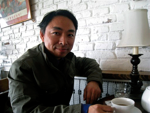 In this photo taken Wednesday, Nov. 4, 2009, Chinese dissident Yang Zili smiles during an interview at a local cafe in Beijing, China. Zili, recently freed after eight years in jail said Thursday he is seeking U.S. President Barack Obama's help in gaining medical parole for two friends jailed with him in 2003 for forming a political study group