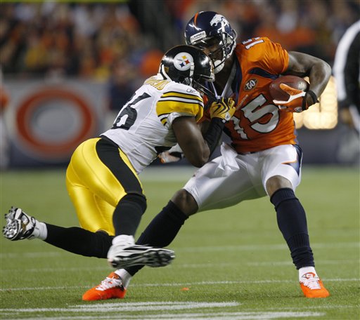 Pittsburgh Steelers cornerback Deshea Townsend, left, tackles Denver Broncos' Brandon Marshall after a pass reception in the first quarter of an NFL football game Monday, Nov. 9, 2009, in Denver.