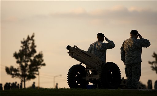 Soldiers salute during the nightly Retreat ceremony on Monday Nov. 9, 2009, at III Corps Headquarters at Fort Hood, Texas, where a memorial service will be held Tuesday for the soldiers killed in last week's mass shootings at Fort Hood.