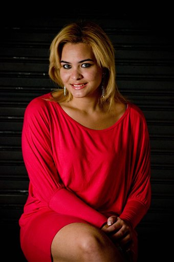 In this photo taken on Saturday, Nov. 7, 2009, student Geisy Arruda poses at her home in Sao Paulo wearing the same dress that she was expelled for wearing on campus at Bandeirante University in Sao Bernardo do Campo, Brazil. The Brazilian government sought an explanation Monday from the private university that expelled Arruda for wearing the dress to class. 