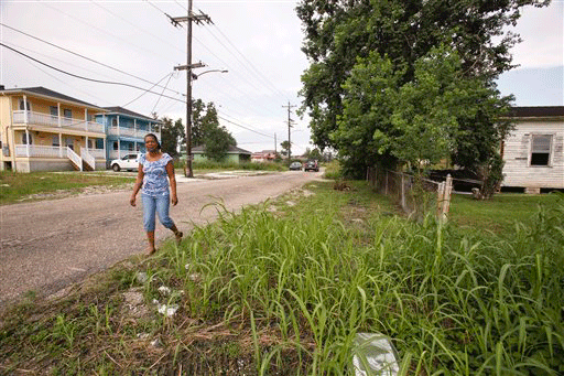Subrina McCrary walks on Flood Street across the street from her home, a blue double in the background, in the lower ninth ward Wednesday, Oct. 14, 2009 in New Orleans. McCrary believes President Barack Obama can support New Orleans' recovery from Hurricane Katrina by creating more jobs and helping build better schools. What she doesn't want is Obama using her Lower 9th Ward neighborhood as just another photo op. On Thursday, Obama makes his first visit to the city since becoming president, and 