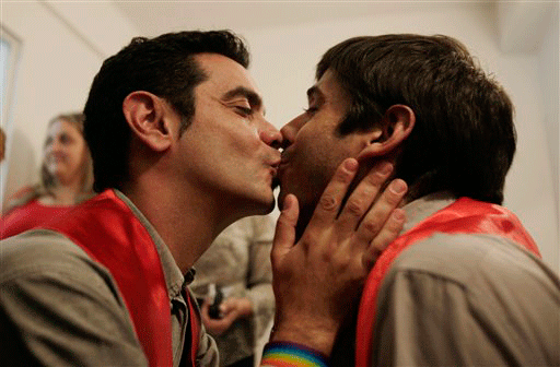 Alex Freyre, right, and Jose Maria Di Bello kiss as they apply to marry at the civil registry in Buenos Aires, Monday, Nov. 16, 2009. A judge declared unconstitutional a law that bans same sex marriage and authorized the marriage between Freyre and Di Bello for Dec. 1. The couple are both are HIV positive and wear the red sashes to promote AIDS awareness.