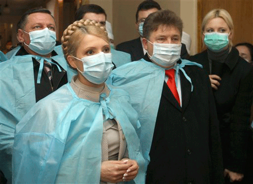 Ukrainian Prime Minister Yulia Tymoshenko, left, wears a face mask as she visits a regional hospital in Lutsk, about 400 km (247 miles) west of Kiev, Ukraine, Monday, Nov. 9, 2009. Ukraine's presidential election in January could be postponed because of swine flu, a newspaper quoted a government official as saying Friday.