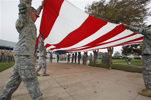 Soldiers from Fort Hood fold a American flag inside Fort Hood in Killeen, Texas, Monday, Nov. 9, 2009 in preparation for President Obama's planned visit on Tuesday. Army psychiatrist Maj. Nidal Malik Hasan is suspected of opening fire on fellow soldiers during a rampage that left 13 people dead on Thursday, Nov. 5, 2009.