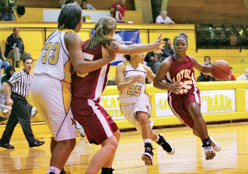 Sociology sophomore and guard Keiva Council dribbles down the court during the Jan. 29 away game against Xavier University.