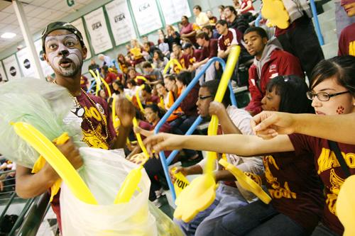 Maroon Platoon Vice President, Carl Harrison, mass communication freshman,hands out balloons at the Loyola-Tulane basketball game.