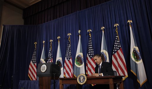 President Barack Obama signs a memorandum for closer consultation between Native America tribes and federal government, Thursday, Nov. 5, 2009, during the White House Tribal Nations Conference at the Interior Department in Washington.