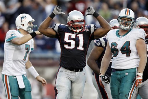 New England Patriots linebacker Jerod Mayo (51) celebrates a stop as Miami Dolphins center Jake Grove (64) and quarterback Chad Henne look on during the fourth quarter of New England's 27-17 win in an NFL football game in Foxborough, Mass., Sunday, Nov. 8, 2009.