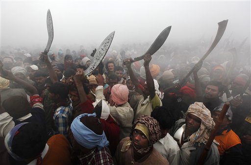 Butchers with butcher knives participate in religious rituals before slaughtering buffalos during a mass sacrifice ceremony at Gadhimai temple in Bariyapur, about 70 kilometers (43 miles) south of Katmandu, Nepal, Tuesday, Nov. 24, 2009. Hundreds of thousands of Hindus gathered at a temple in southern Nepal on Tuesday for a ceremony involving the slaughter of more than 200,000 animals, a festival that has drawn the ire of animal-welfare protesters. 