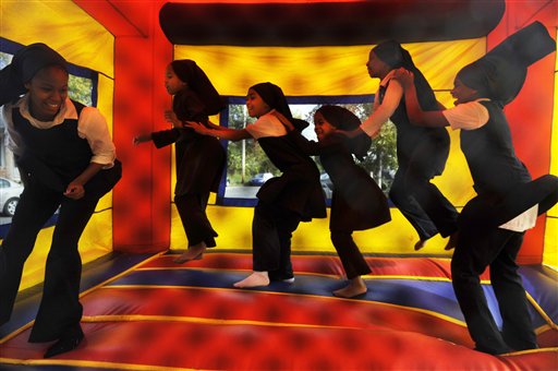 Muhammad University of Islam students form a bouncing 'train' inside an inflatable bounce castle during the 8th annual Stop the Killy rally for peace and Thanksgiving turkey giveaway across from the McKinley Alumni Center in Baton Rouge, La., Tuesday, Nov. 24, 2009. The students are from left, Tynetta Muhammad, Lyric Muhammad, Aishah Muhammad, Lakiya Muhammad, Maryam Muhammad and Ava Muhammad.
