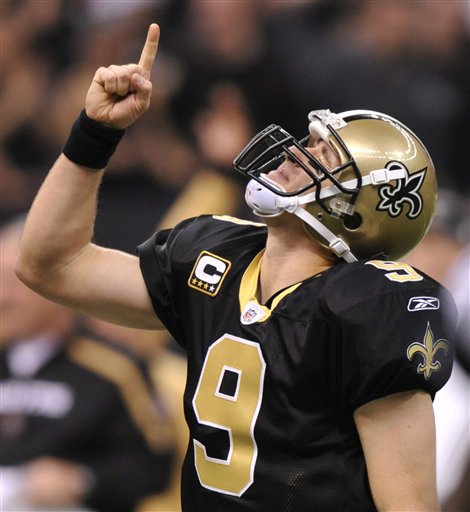 New Orleans Saints quarterback Drew Brees points upwards after his 20-yard touchdown pass to Marques Colston during the fourth quarter of an NFL football game against the New England Patriots, Monday, Nov. 30, 2009, in New Orleans.