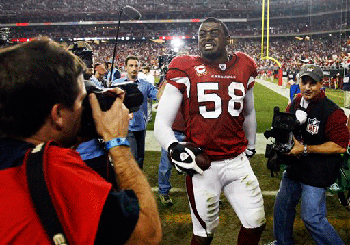 Arizona Cardinals' Karlos Dansby celebrates after the Cardinals defeated the Green Bay Packers 51-45 in overtime in an NFL wild-card playoff football game Sunday, Jan. 10, 2010, in Glendale, Ariz.
